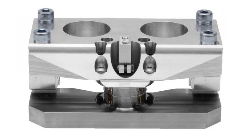 Close-up of the HBT: upper clamp block with four bolts, torque sensor in the center and base plate underneath