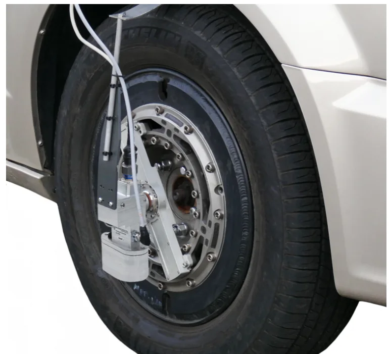 Car wheel fitted with a wheel force transducer and a TrueSlip optical sensor facing the road