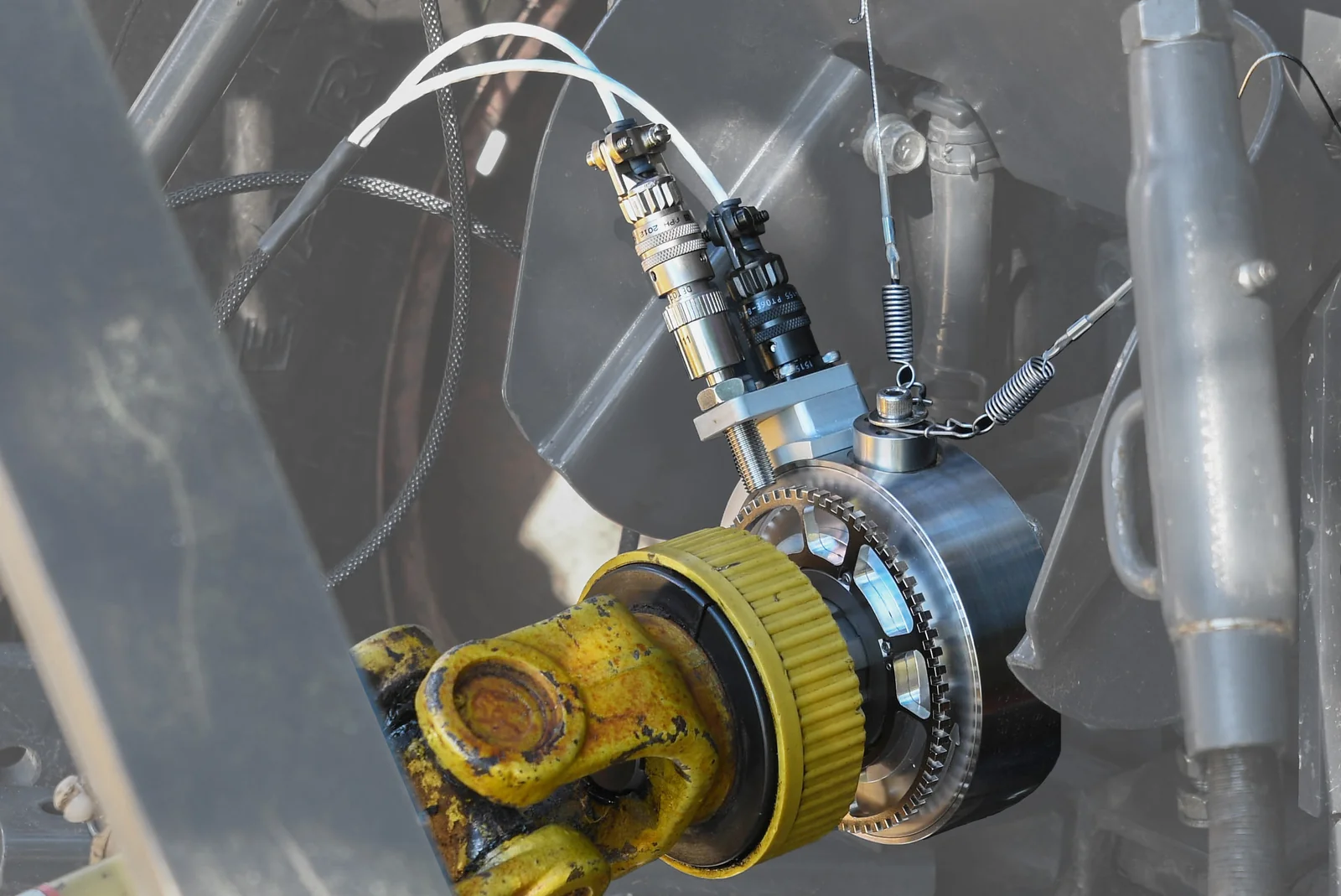 PTO2 torque transducer on a tractor PTO shaft, connected to the implement drive shaft, with its restraint cables