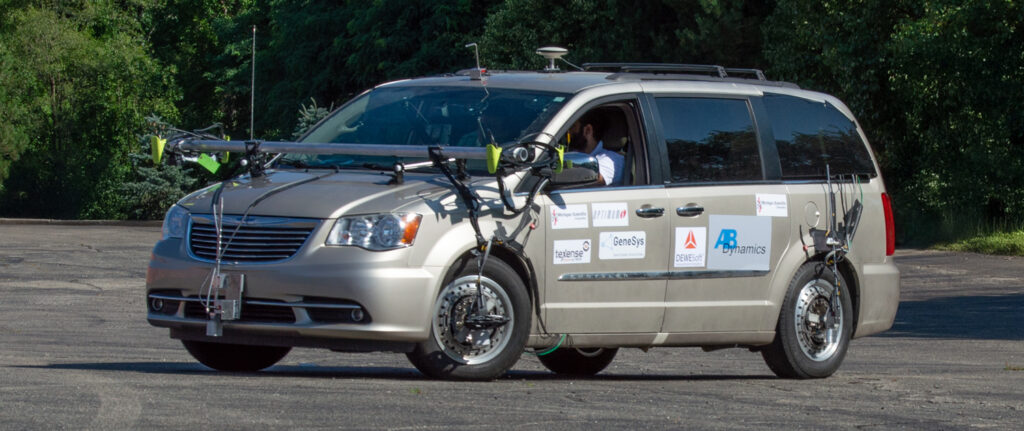 Minivan fitted with wheel force transducers and sensors on a test track