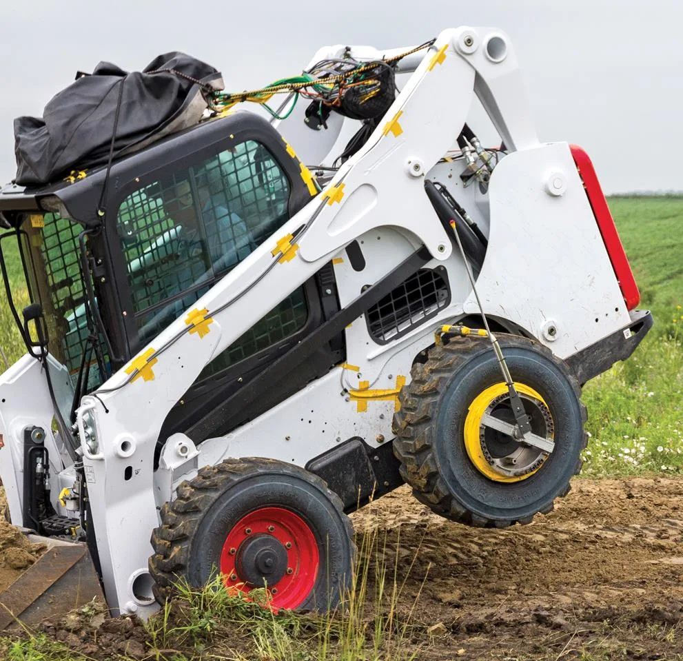 Skid-steer loader fitted with wheel force transducers